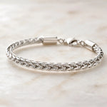 Side-profile view of the Evelyn fine silver bracelet revealing the dimensional handwoven silver construction and elegant braided design.