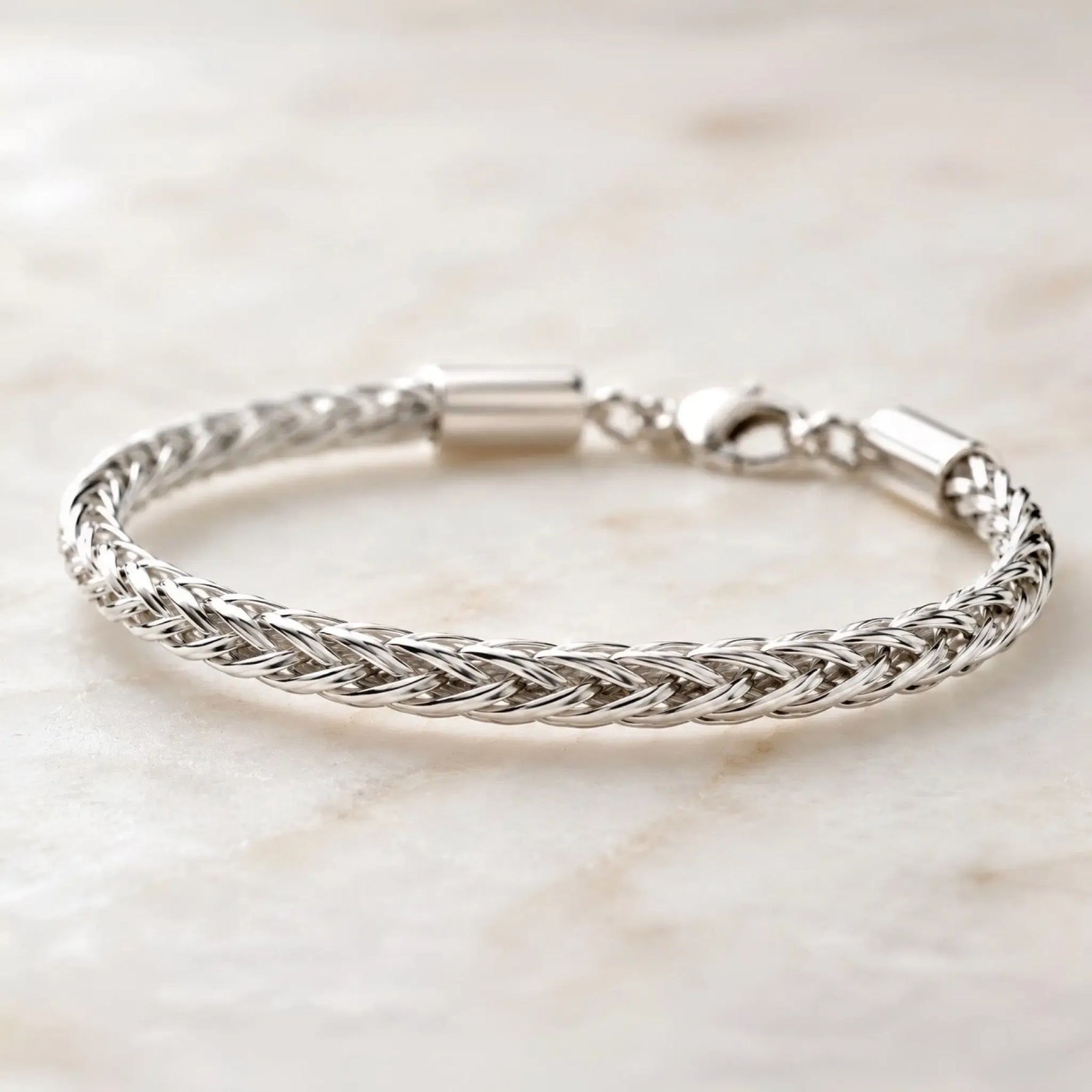 Side-profile view of the Evelyn fine silver bracelet revealing the dimensional handwoven silver construction and elegant braided design.