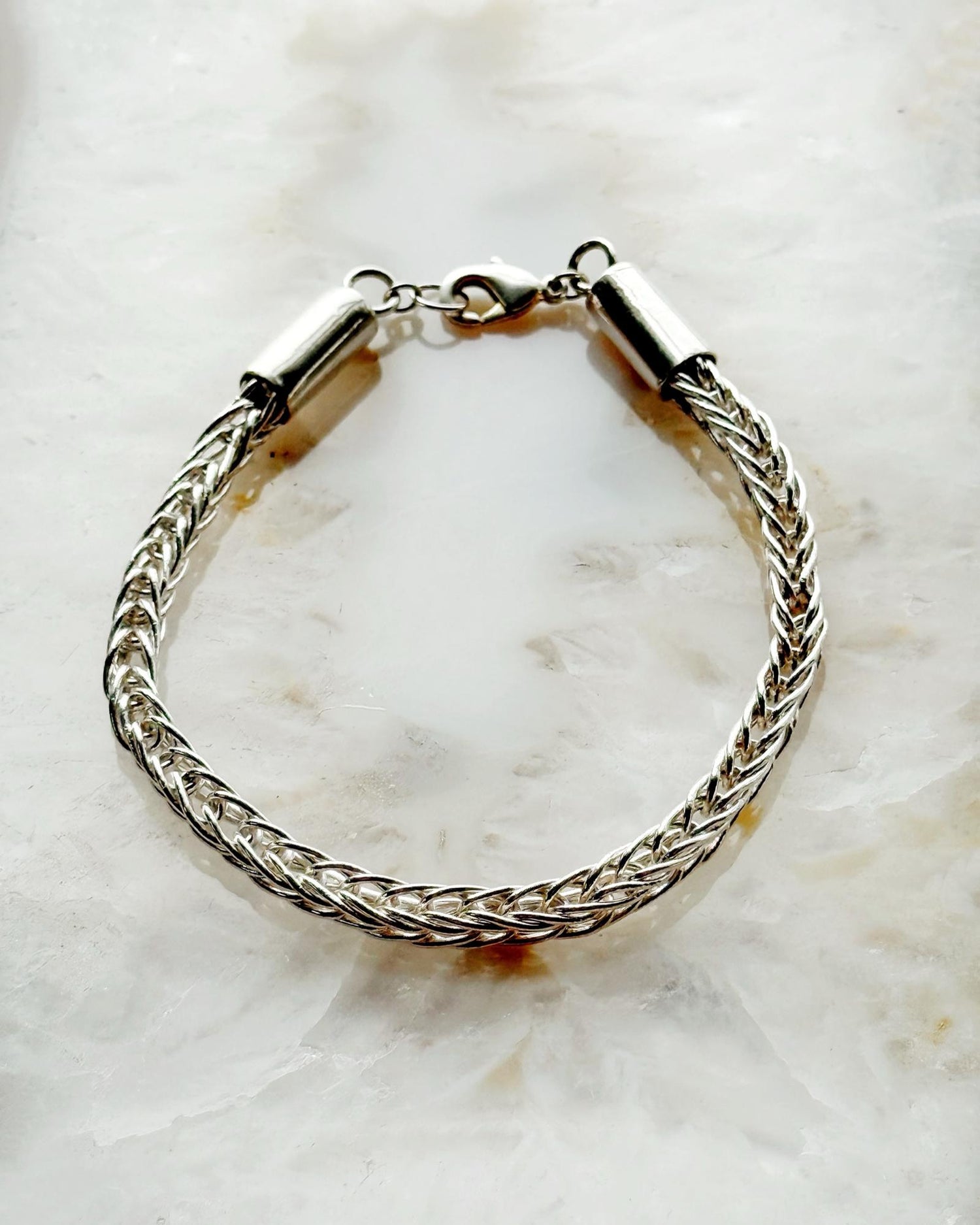 Evelyn Fine Silver Bracelet by Carabella by Cheryl, handcrafted in Canada from .999 fine silver wire with a sterling silver clasp—each link hand-cut, fused, and woven by hand for a luxurious artisan finish.