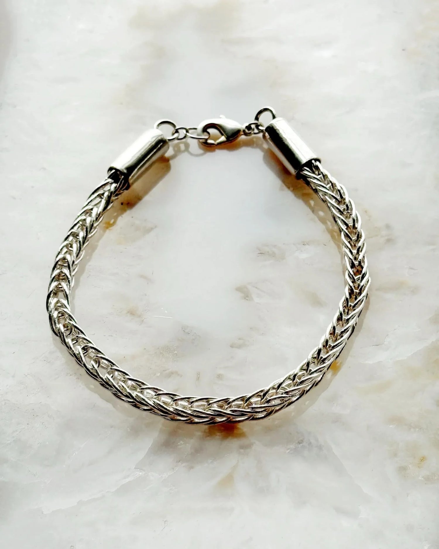 Evelyn Fine Silver Bracelet by Carabella by Cheryl, handcrafted in Canada from .999 fine silver wire with a sterling silver clasp—each link hand-cut, fused, and woven by hand for a luxurious artisan finish.