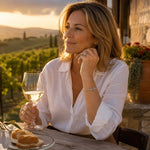 Woman wearing the Gemma handwoven .999 fine silver bracelet at a vineyard terrace during golden hour, styled with a white linen blouse.