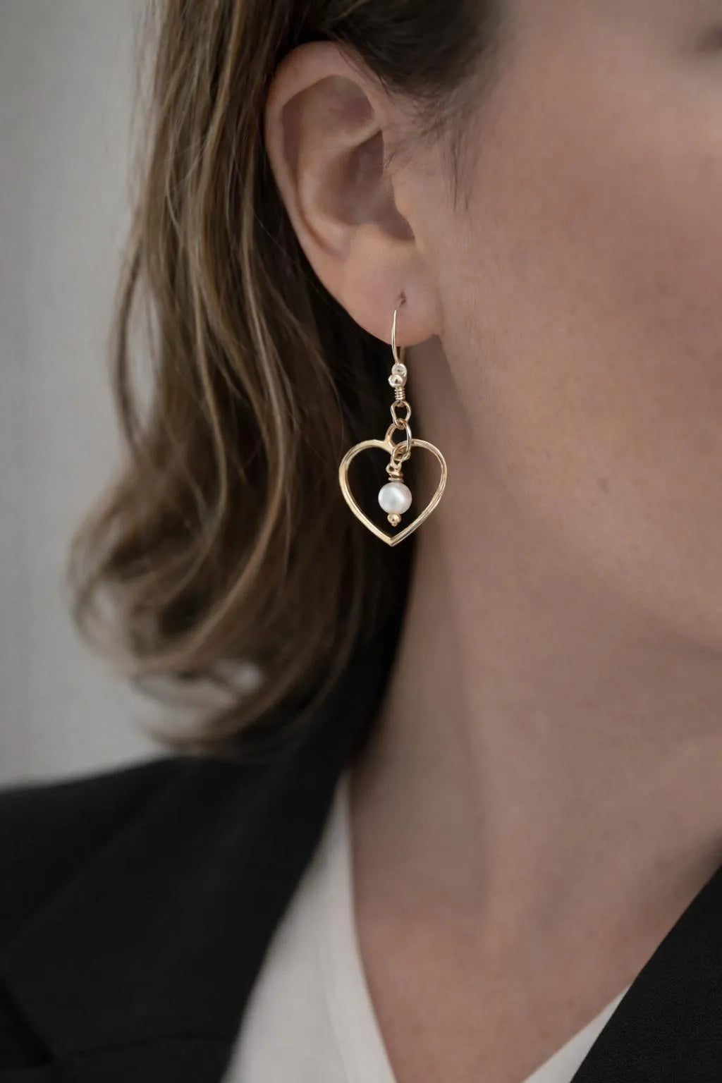 Harlow gold and pearl earrings worn on model, elegant heart drop earrings with honey opal and pearl