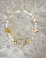 Luxury honey opal and gold stretch bracelet with heart centerpiece, designed for effortless layering and everyday elegance
