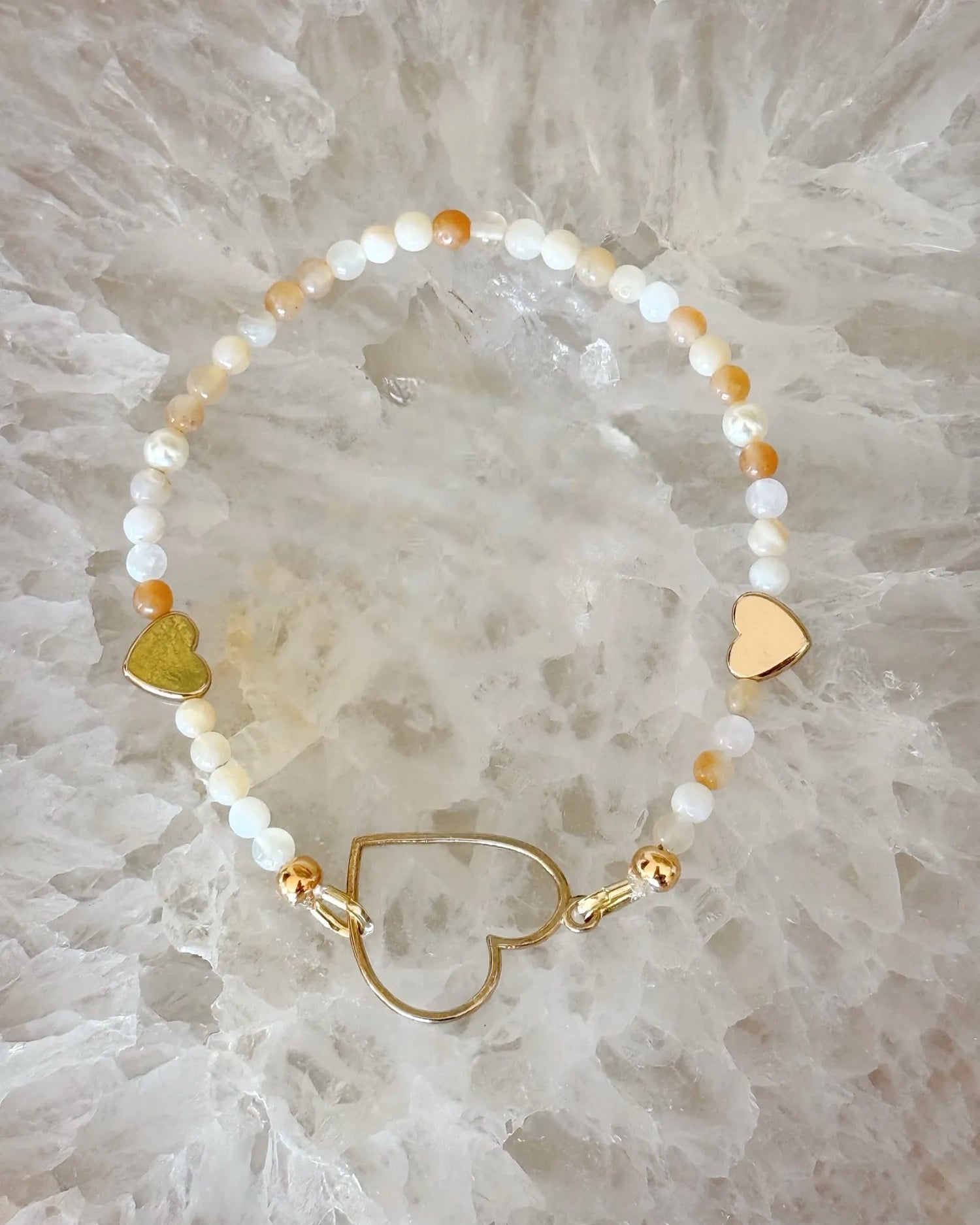 Luxury honey opal and gold stretch bracelet with heart centerpiece, designed for effortless layering and everyday elegance