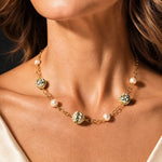 Elegant woman wearing the Imperial Blossom Necklace with rare Japanese Tensha beads, Swarovski® Crystal Pearls, and gold chain links in a luxury fashion-inspired jewelry photograph.