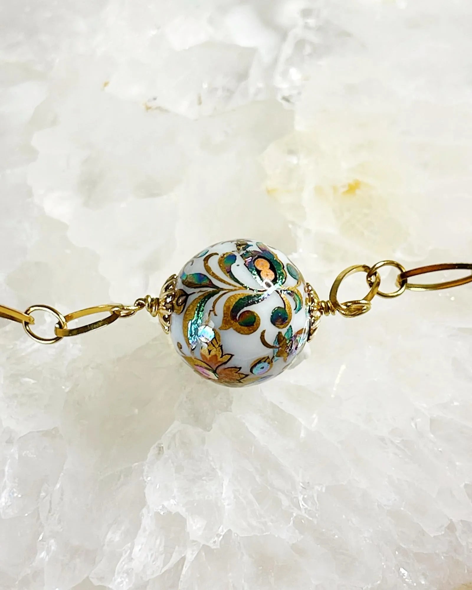 Close-up of the Imperial Blossom Necklace showing the detailed Japanese Tensha bead with floral artwork, framed by gold-plated chain links and Austrian Crystal pearls.