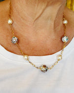 Model wearing the Imperial Blossom Necklace featuring Japanese Tensha beads, Austrian Crystal pearls, and gold-plated chain links. Handcrafted in Canada by Carabella by Cheryl.