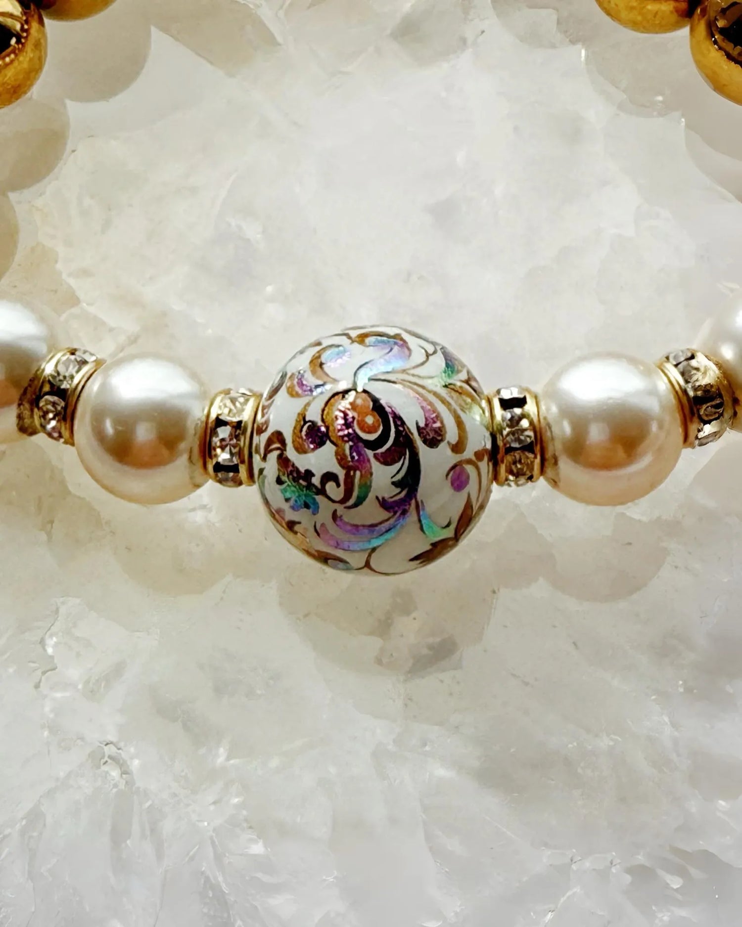 Close-up of Imperial Blossom Bracelet showing the intricate Japanese Tensha bead with floral artwork, framed by Austrian Crystal pearls and gold-plated hematite.