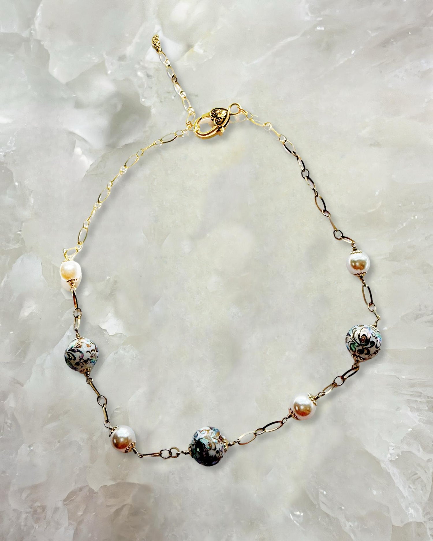 Imperial Blossom Necklace featuring rare Japanese Tensha beads, Austrian Crystal pearls, and gold-plated chain links displayed on a crystal background. Handcrafted in Canada by Carabella by Cheryl.