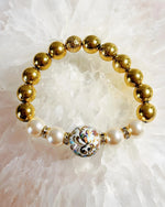 Imperial Blossom Stretch Bracelet by Carabella by Cheryl featuring a rare Japanese Tensha focal bead, Austrian Crystal cream rose pearls, gold-plated hematite beads, and crystal rondelles, handcrafted in Canada.
