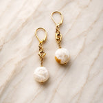 Jewel Cracked Agate Coin Earrings featuring genuine cracked agate gemstones and gold accents displayed on a soft ivory marble surface in a luxury product photograph.
