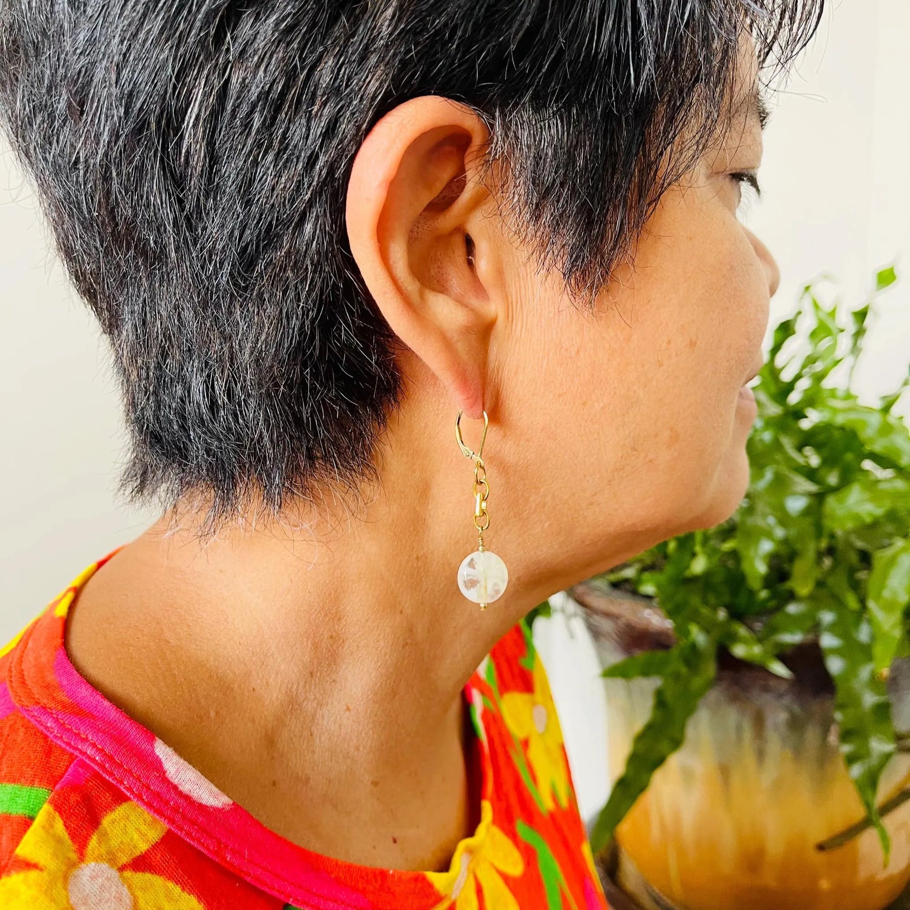 Model wearing Jewel Cracked Agate Earrings featuring round cracked agate beads, gold-plated links, and 14k gold-filled lever-back ear wires. Handcrafted in Canada by Carabella by Cheryl.