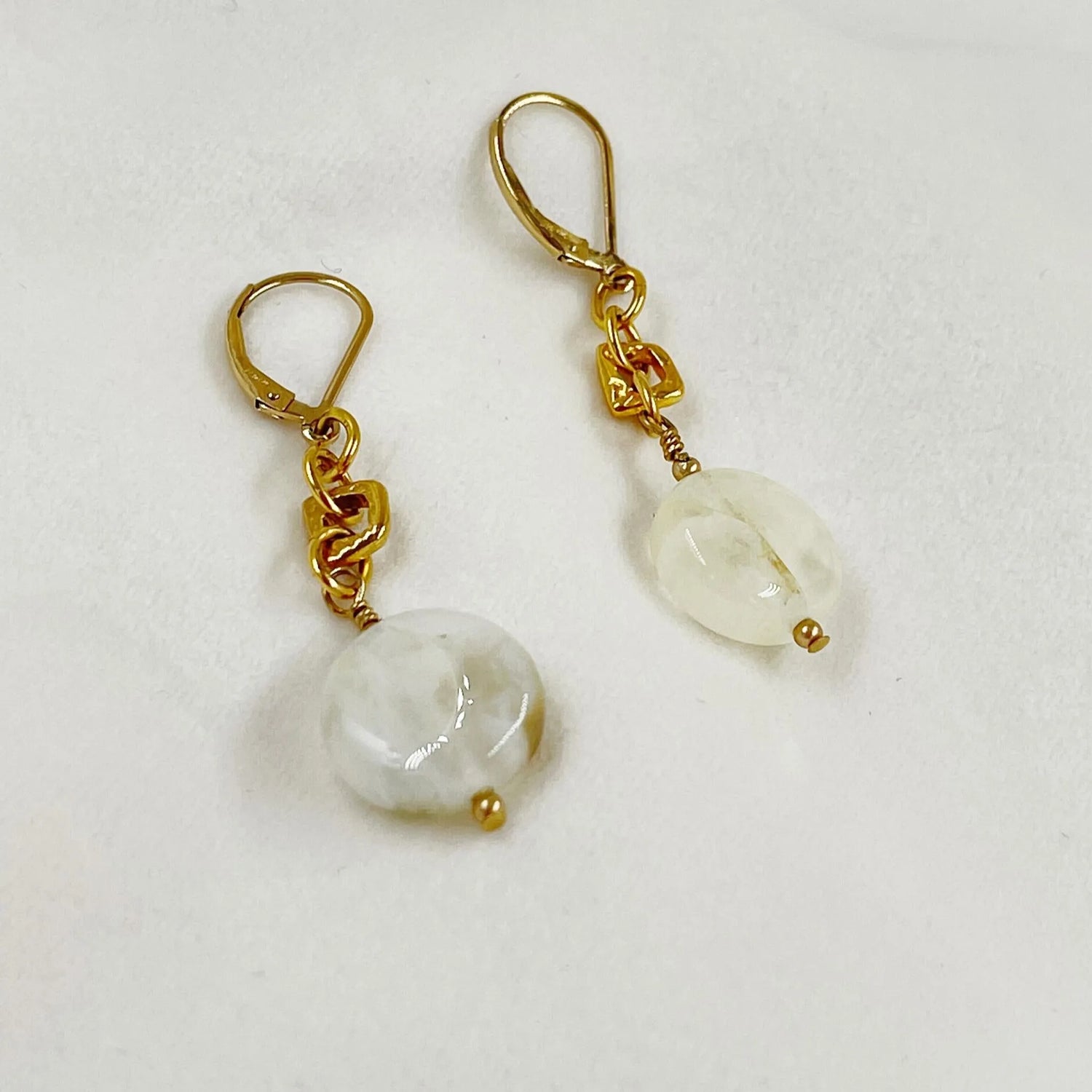 Jewel Cracked Agate Earrings displayed on a white jewelry pillow, featuring cracked agate beads, gold-plated links, and 14k gold-filled lever-back ear wires.