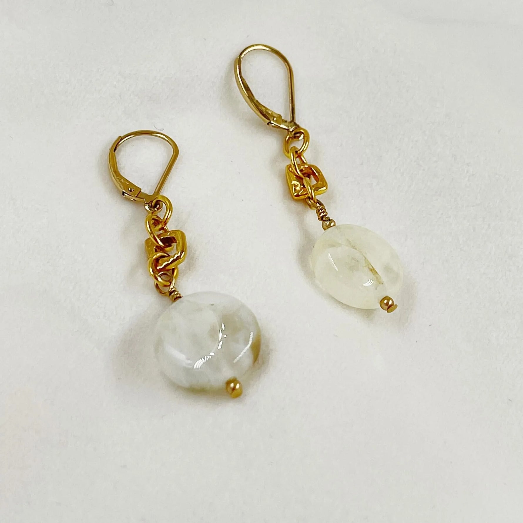 Jewel Cracked Agate Earrings displayed on a white jewelry pillow, featuring cracked agate beads, gold-plated links, and 14k gold-filled lever-back ear wires.