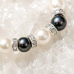 Macro detail of the Juanita Swarovski® Crystal Pearl bracelet featuring cream and dark grey Swarovski® Crystal Pearls, silver crystal rondelles, and handcrafted detailing.