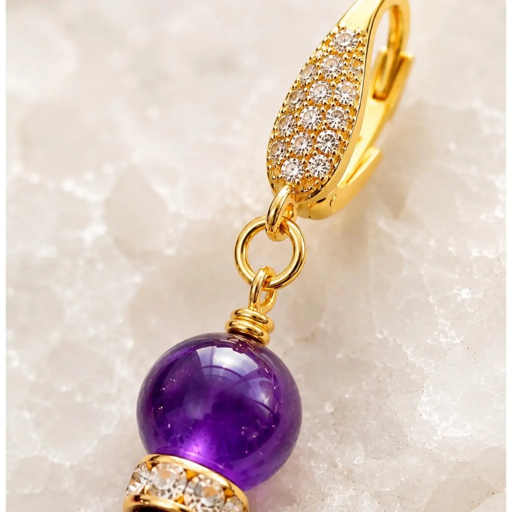 Macro detail of Kalei handcrafted amethyst gemstone earrings highlighting the 18k gold-plated CZ leverback, hand wire wrapping, Austrian crystal rondelle, and premium craftsmanship.