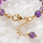 Close-up of the Kalei bracelet lobster clasp, extender chain, Austrian crystal rondelles, and natural amethyst gemstone detail.