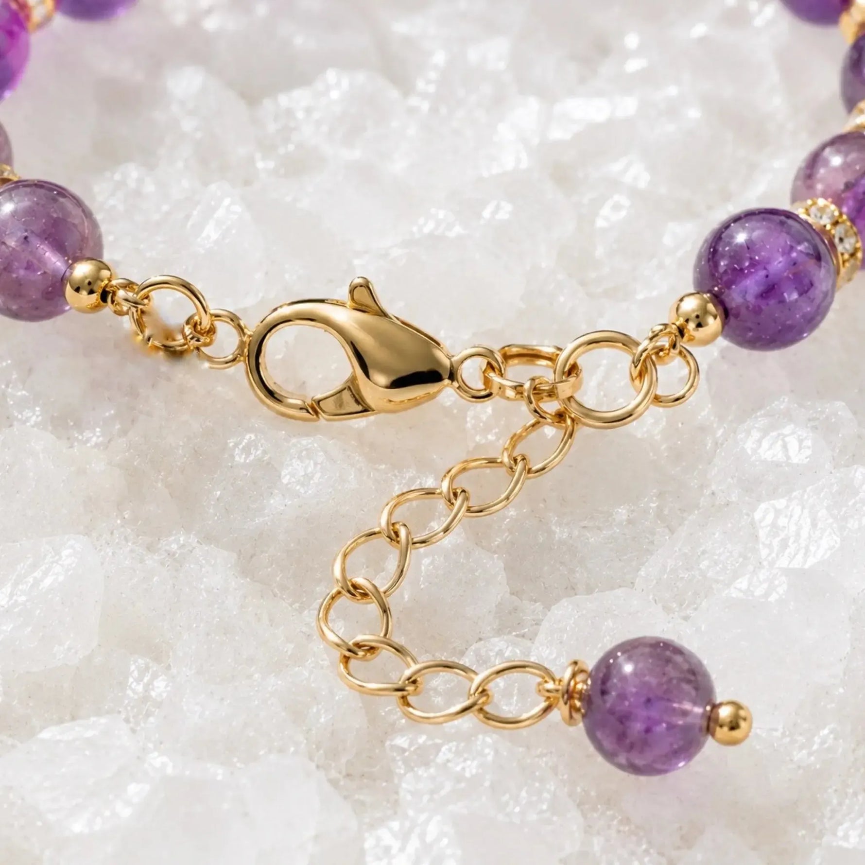 Close-up of the Kalei bracelet lobster clasp, extender chain, Austrian crystal rondelles, and natural amethyst gemstone detail.