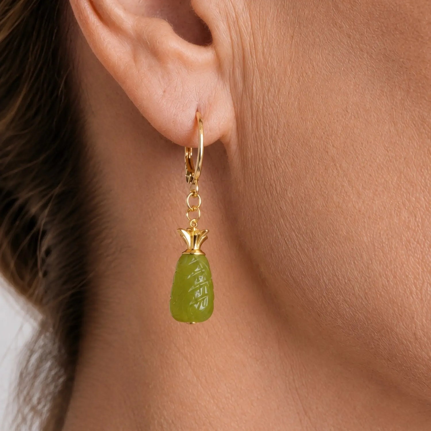 Close-up detail of Layla carved jade drop earring with polished gold accents, highlighting intricate jade carving and refined craftsmanship.