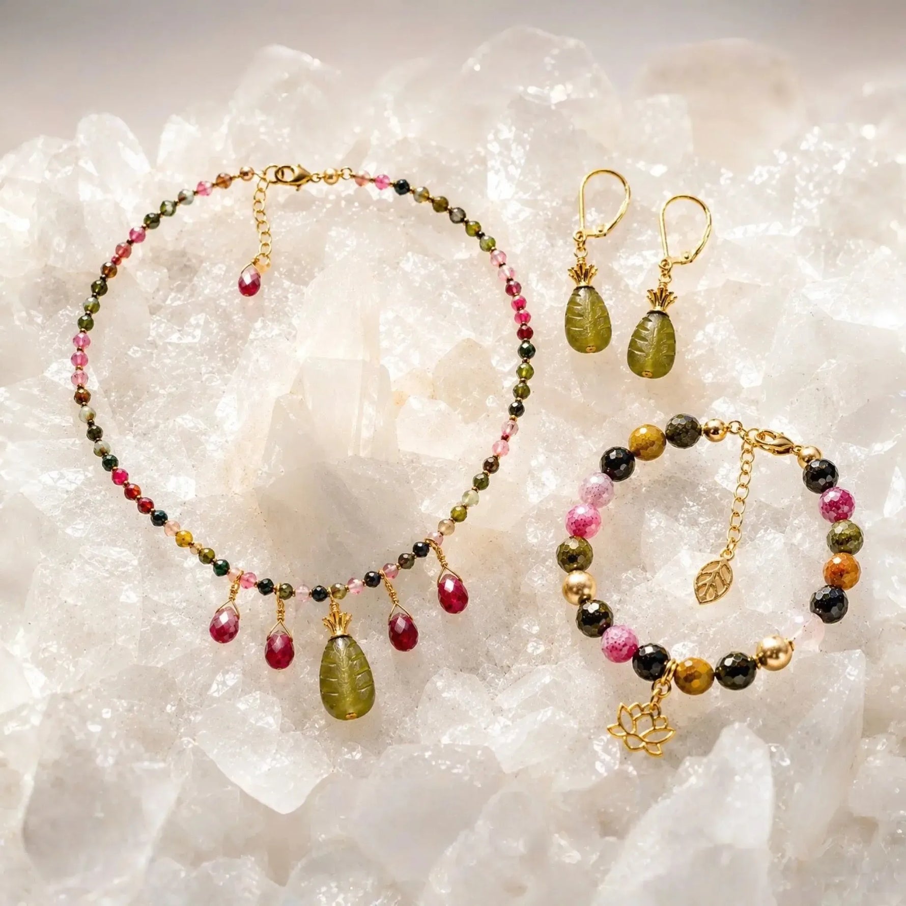Layla Collection featuring the Layla Tourmaline Necklace, Layla Tourmaline Bracelet, and Layla Jade Earrings arranged on white quartz with coordinating tourmaline gemstones and gold accents.