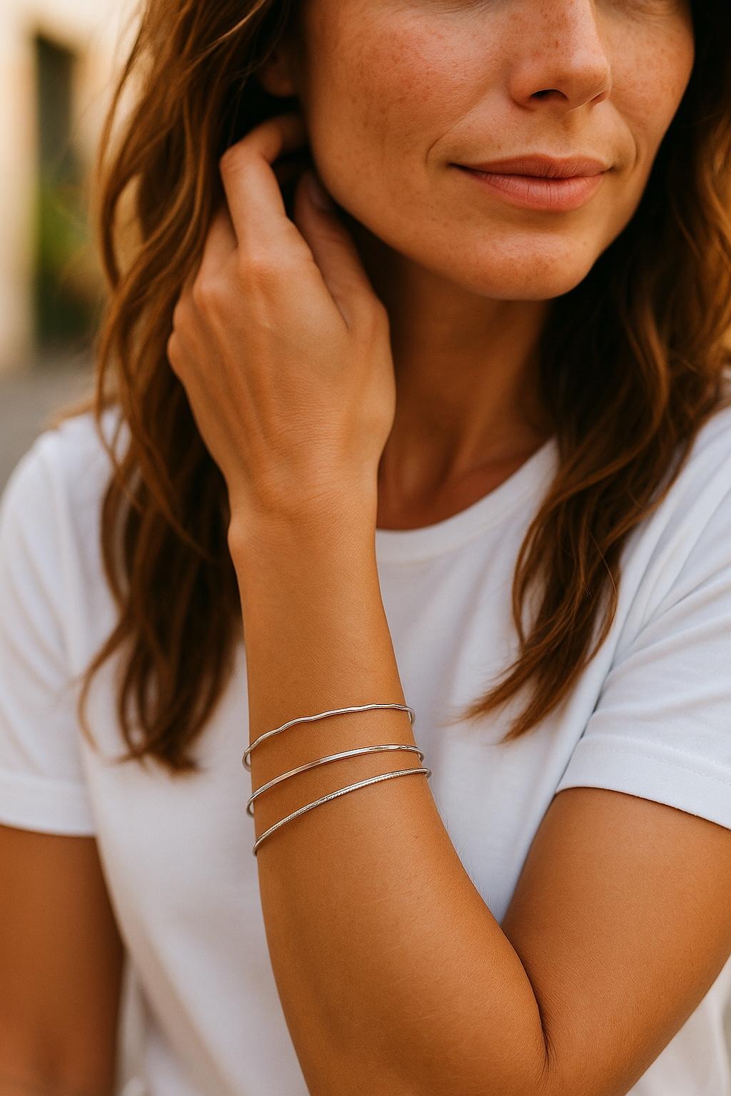 Handcrafted sterling silver bangles worn on wrist, minimalist luxury silver bracelets for women by Carabella by Cheryl
