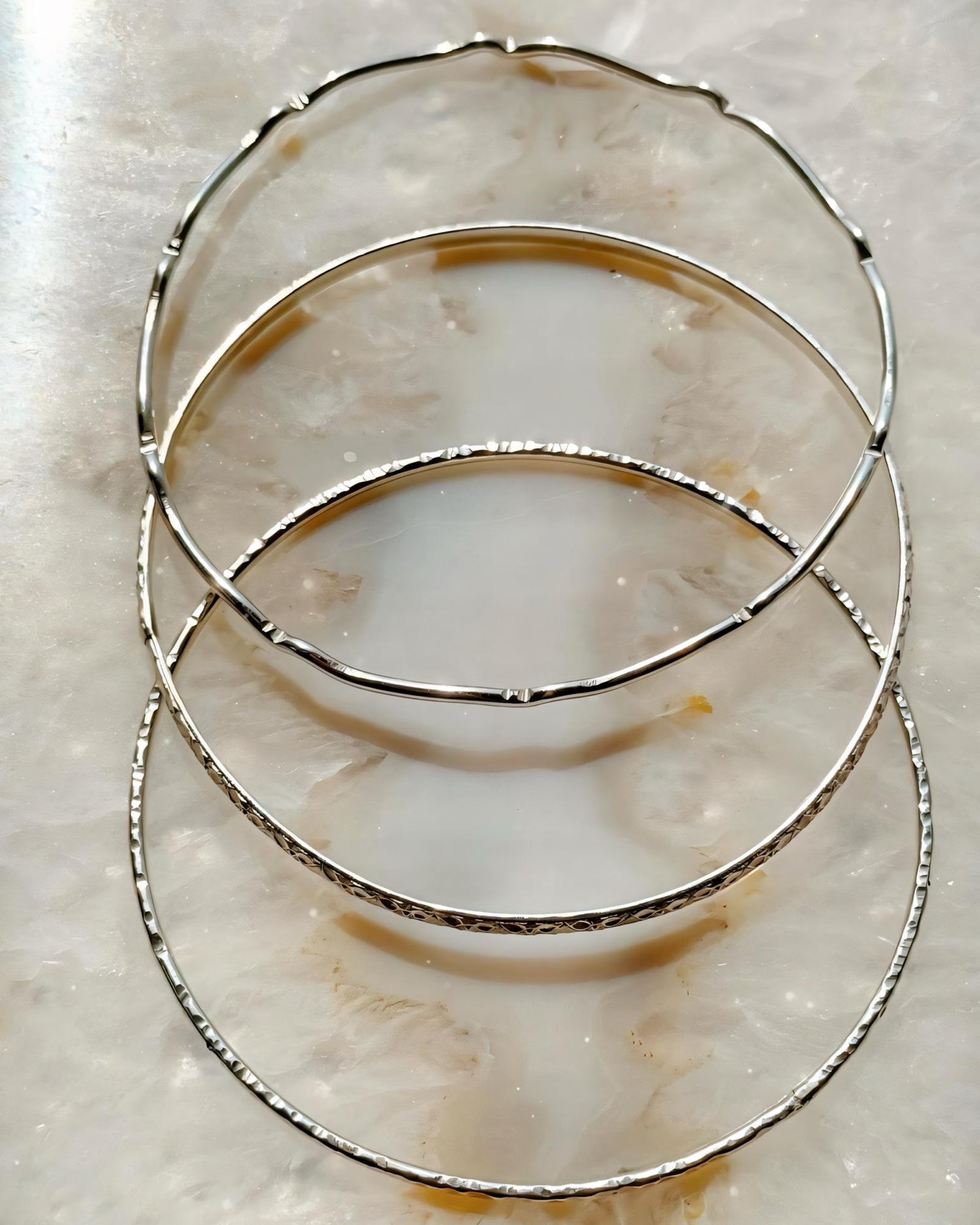Hand-textured sterling silver bangles handcrafted in Canada, Lilith minimalist silver bangle set by Carabella by Cheryl