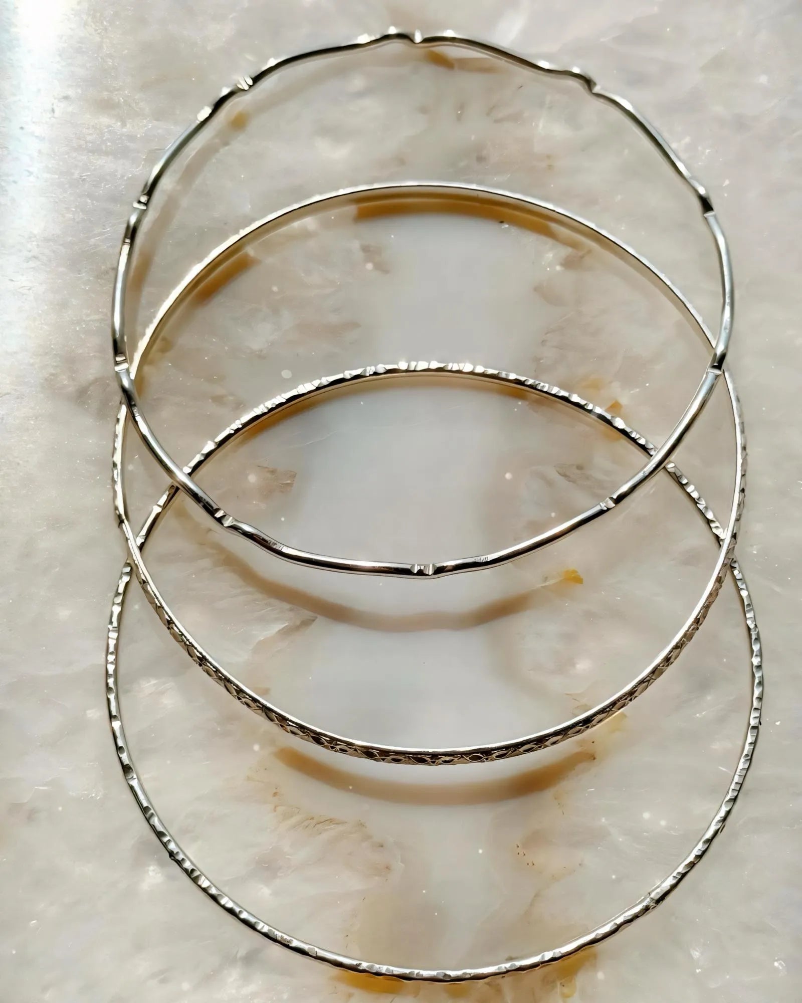 Hand-textured sterling silver bangles handcrafted in Canada, Lilith minimalist silver bangle set by Carabella by Cheryl