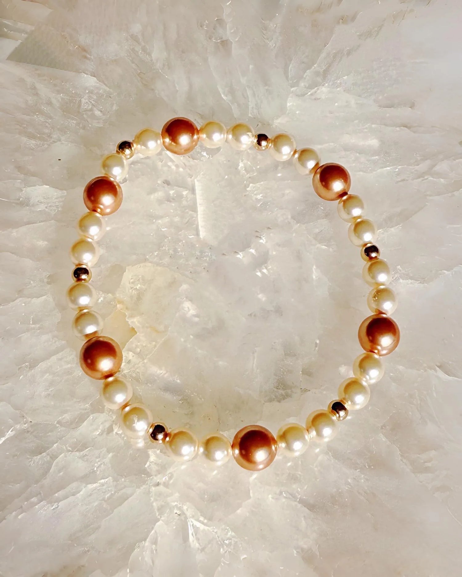 Meli rose gold and cream pearl bracelet with Austrian crystal pearls on natural stone background