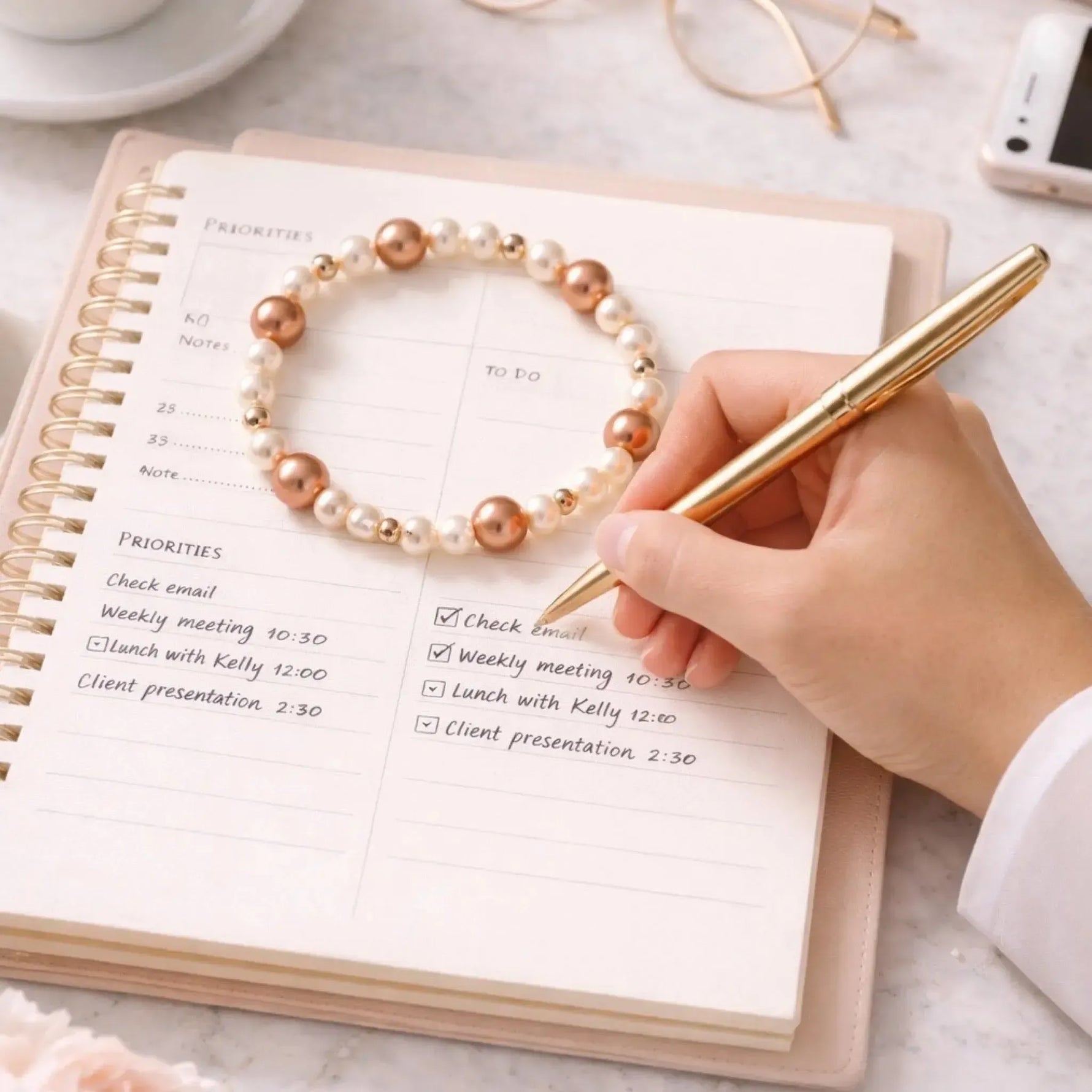 Meli Swarovski® Crystal Pearl Bracelet styled with a planner and gold pen, illustrating refined everyday elegance and professional versatility.