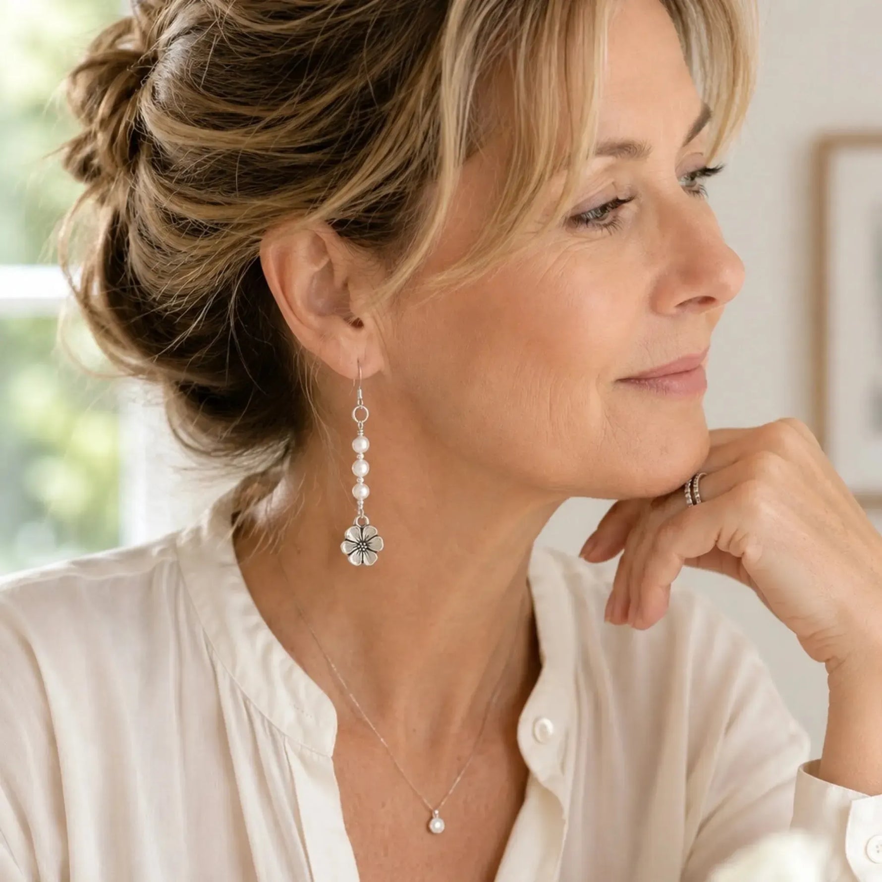 Woman wearing Mia Freshwater Pearl Earrings in a refined professional setting, styled with an ivory blouse and natural light for an elegant everyday look.