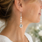Woman wearing Mia Freshwater Pearl Earrings in side profile, showing the elegant drop length, freshwater pearls, sterling silver details, and apple blossom charm.