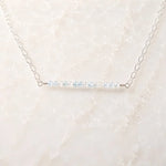 Angled view of the Morgan Bar Necklace featuring faceted morganite gemstones and sterling silver craftsmanship.