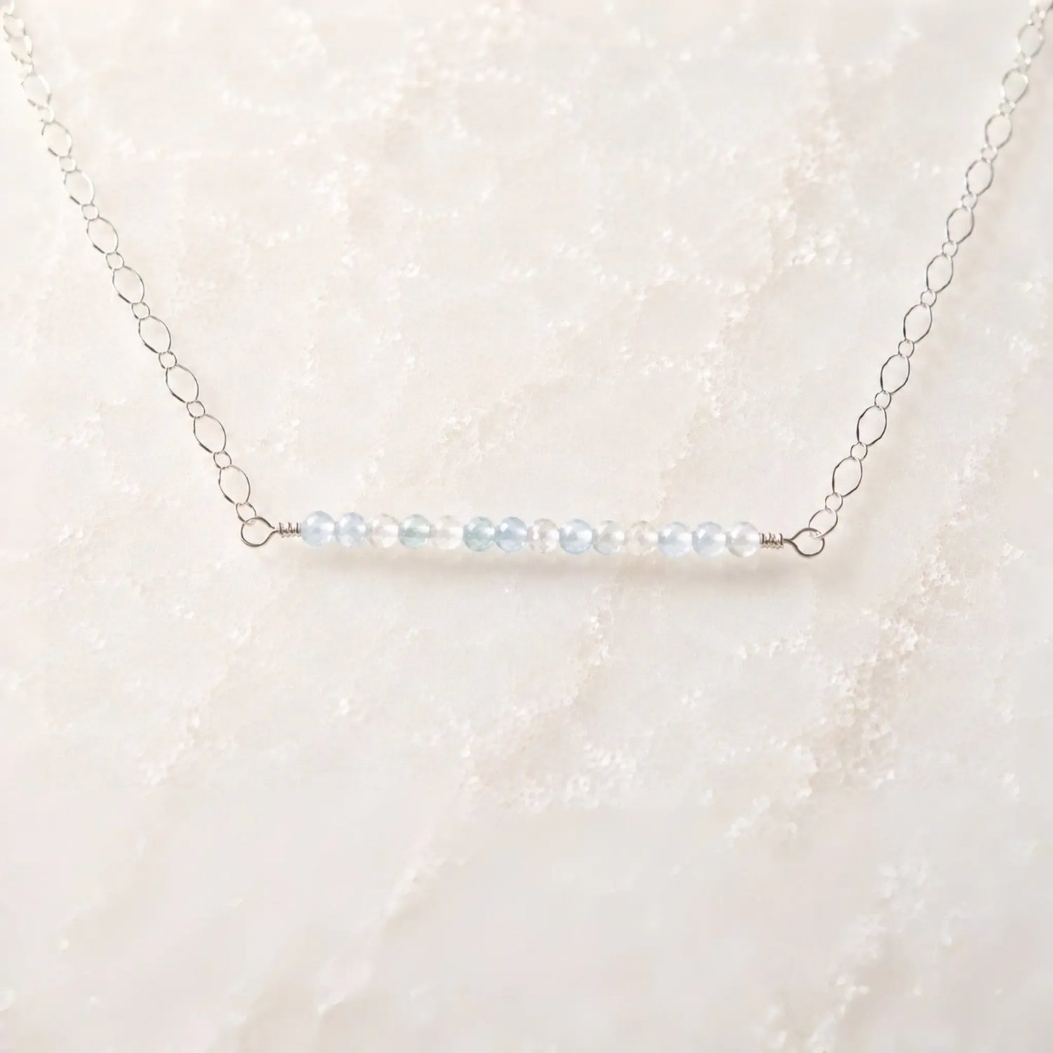 Angled view of the Morgan Bar Necklace featuring faceted morganite gemstones and sterling silver craftsmanship.