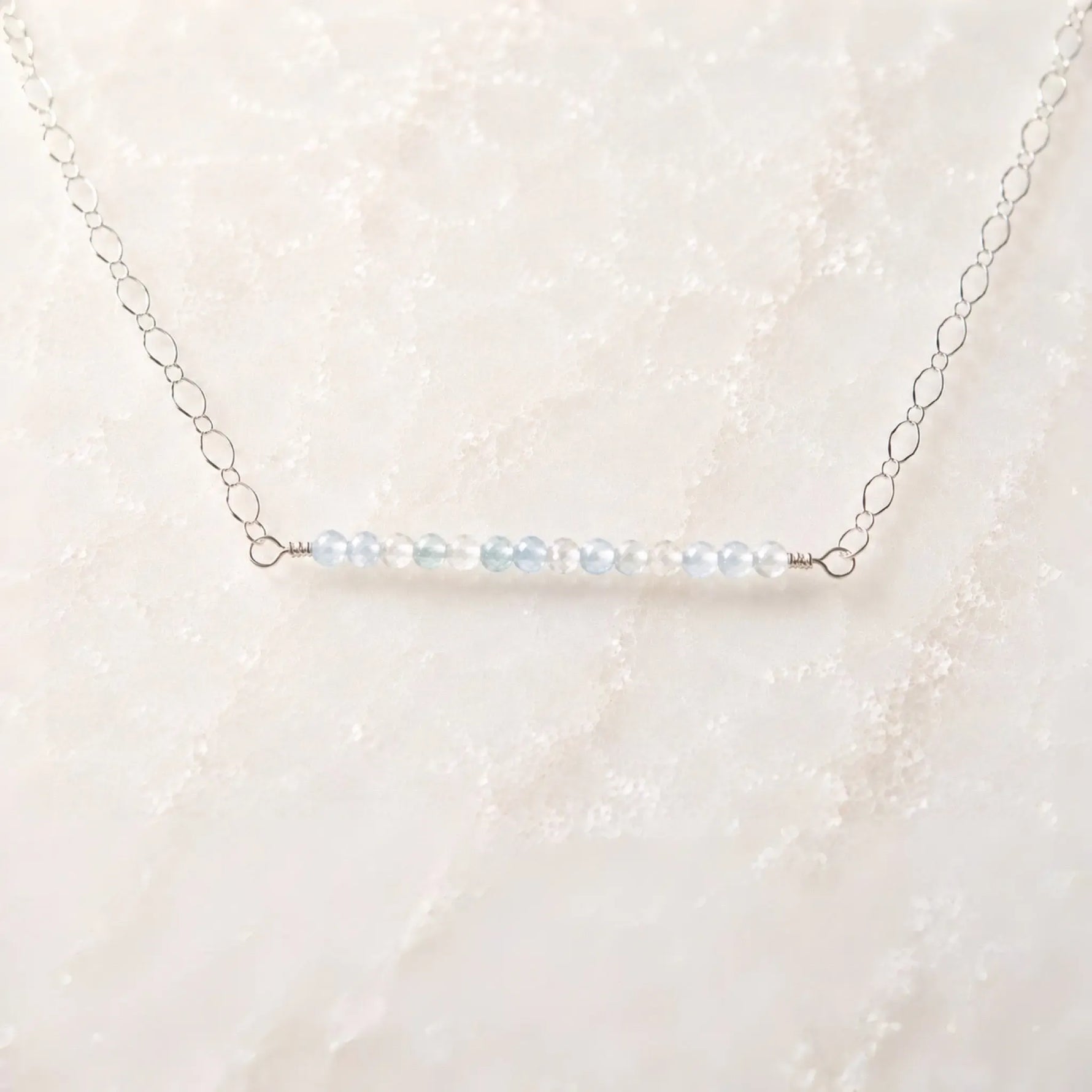 Angled view of the Morgan Bar Necklace featuring faceted morganite gemstones and sterling silver craftsmanship.