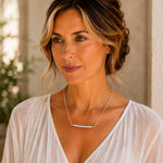 Elegant woman wearing the Morgan Bar Necklace with faceted morganite gemstones and sterling silver in a refined Mediterranean setting.