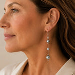 Close-up profile of Natasha Swarovski® Crystal Pearl Earrings showing their graceful length, sterling silver details, and natural movement when worn.