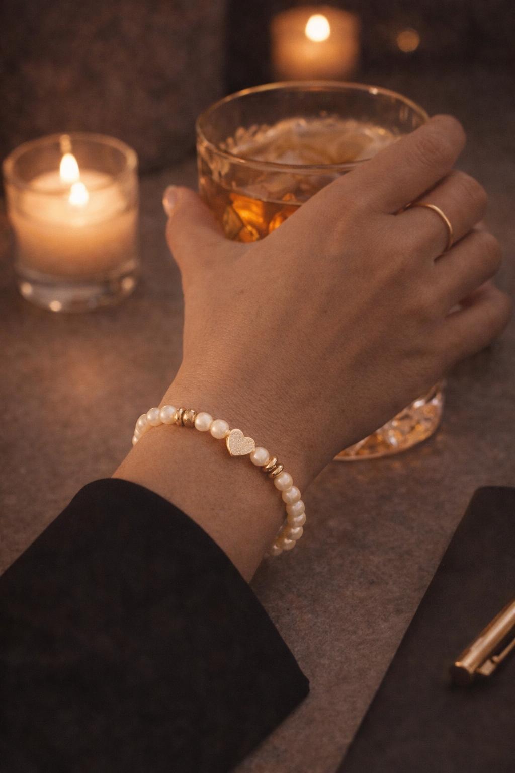 Pandora pearl and gold heart bracelet styled for evening wear with soft candlelight and relaxed elegance