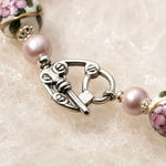 Close-up of the Peony bracelet's sterling silver toggle clasp with Murano glass floral beads and Swarovski® Crystal Pearls.