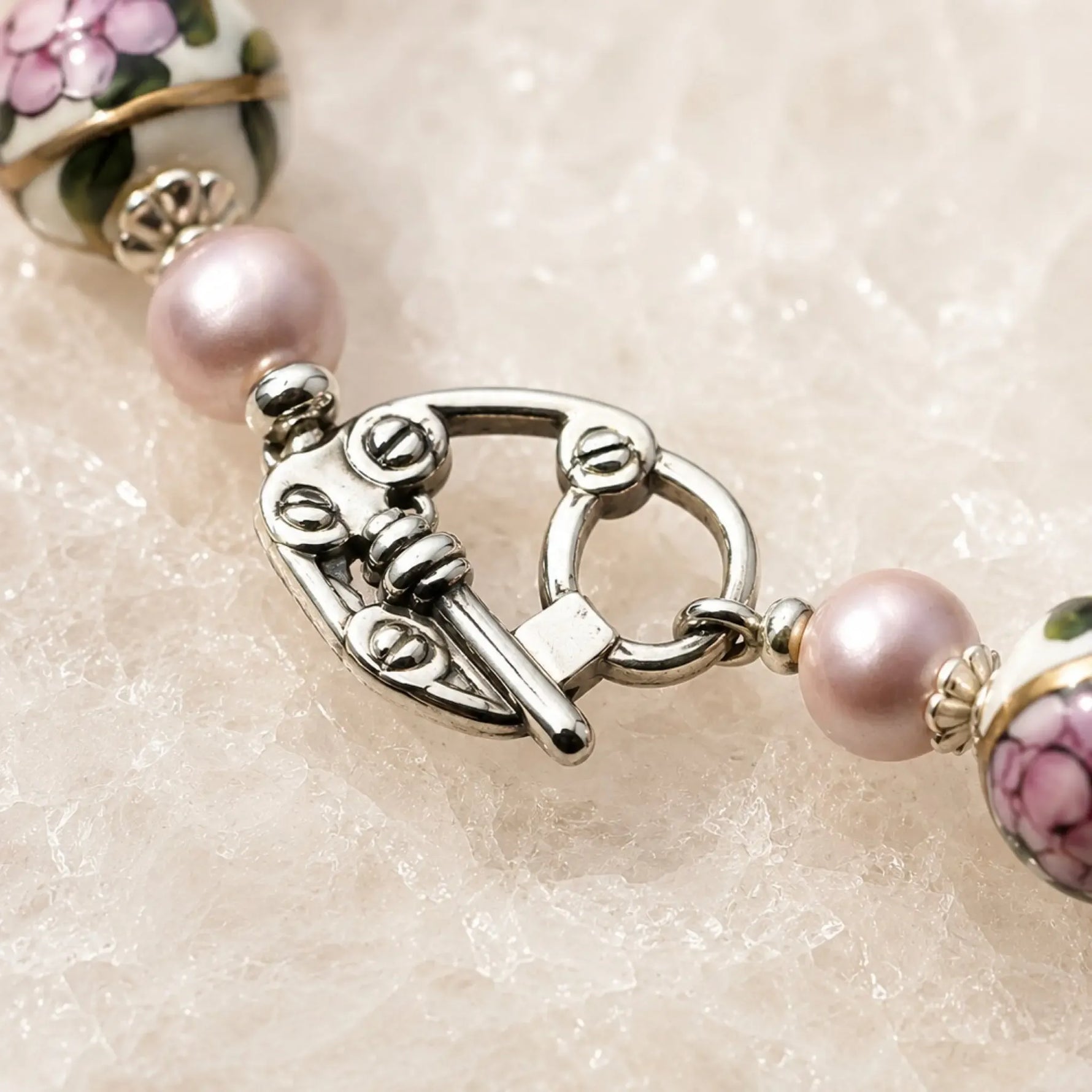 Close-up of the Peony bracelet's sterling silver toggle clasp with Murano glass floral beads and Swarovski® Crystal Pearls.