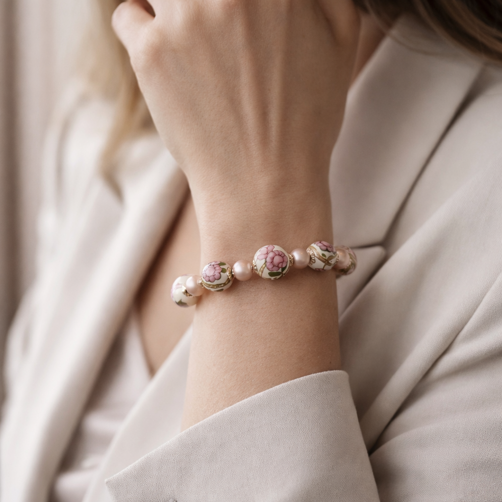 Peony Murano glass bracelet worn on the wrist, featuring hand-painted floral Murano beads and soft blush crystal pearls in an elegant, refined Carabella lifestyle setting.