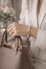 Peony Murano glass bracelet showcasing the sculptural toggle clasp and floral Murano beads, styled on the wrist in a soft, sophisticated Carabella luxury lifestyle scene.