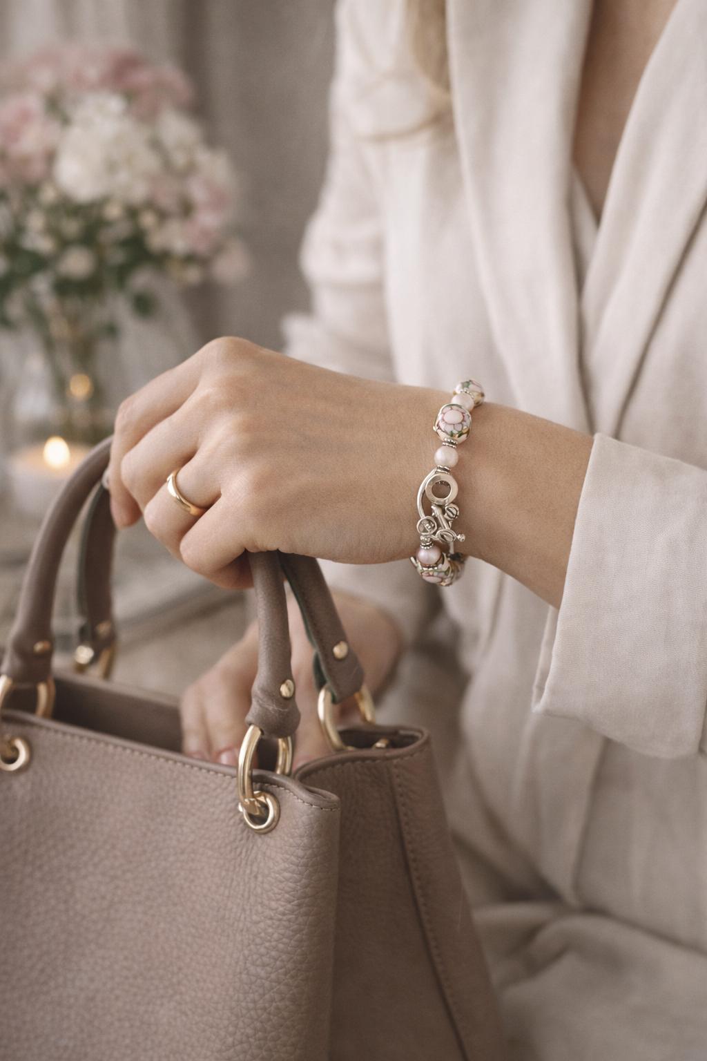 Peony Murano glass bracelet showcasing the sculptural toggle clasp and floral Murano beads, styled on the wrist in a soft, sophisticated Carabella luxury lifestyle scene.