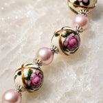 Luxury macro of hand-painted Murano glass floral beads with pink Swarovski® Crystal Pearls and sterling silver bead caps on the Peony bracelet.
