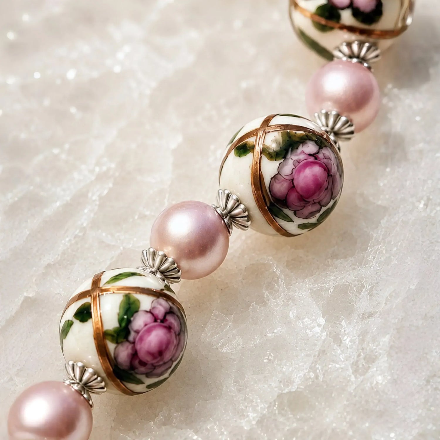 Luxury macro of hand-painted Murano glass floral beads with pink Swarovski® Crystal Pearls and sterling silver bead caps on the Peony bracelet.