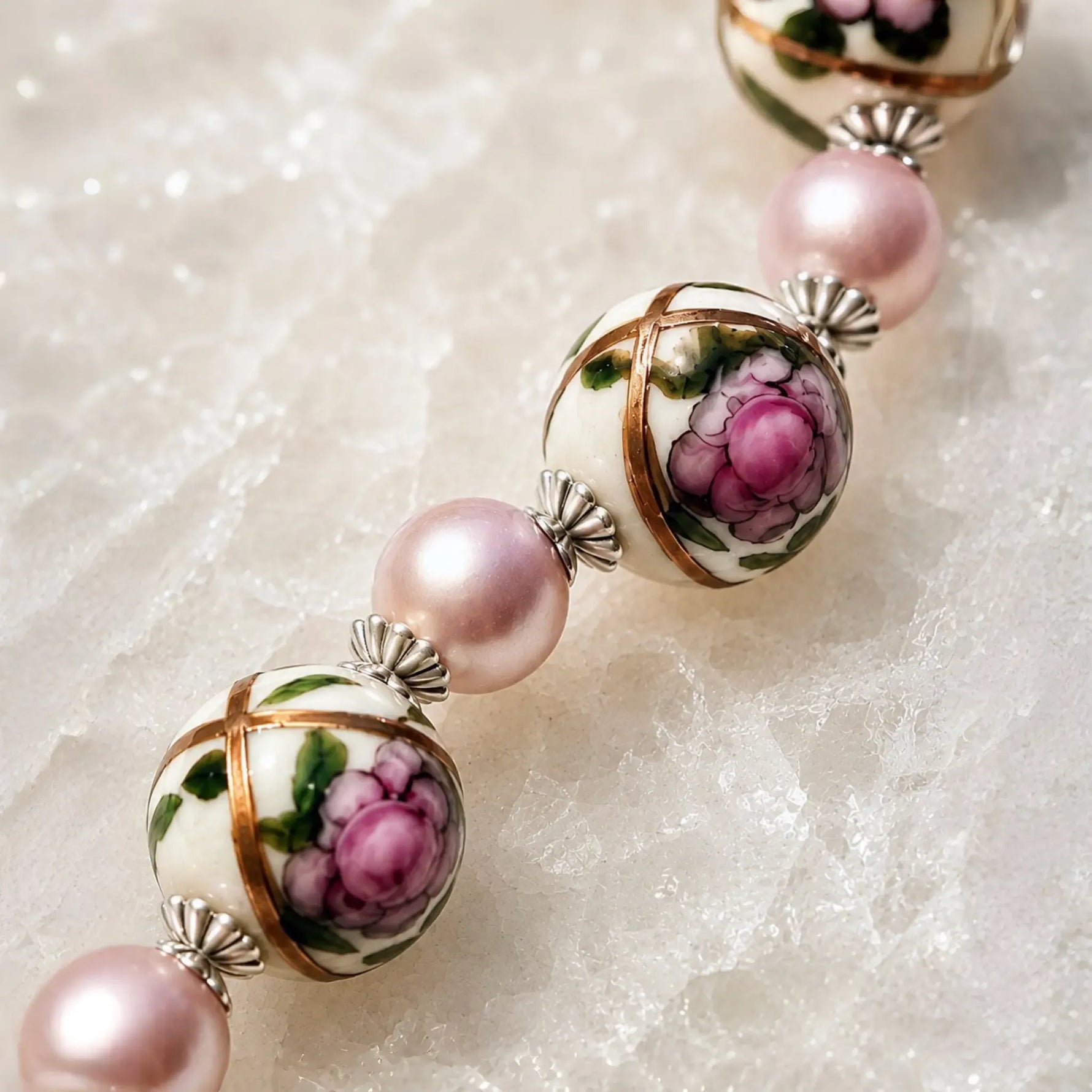 Luxury macro of hand-painted Murano glass floral beads with pink Swarovski® Crystal Pearls and sterling silver bead caps on the Peony bracelet.