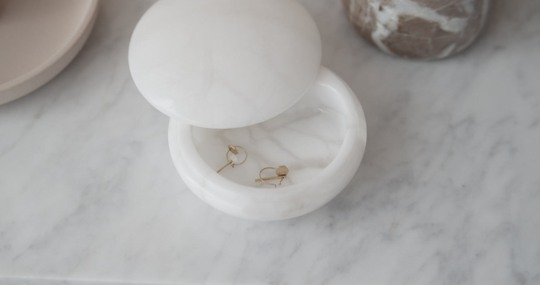 Carabella by Cheryl signature jewelry styled in soft natural light, showcasing refined bracelets and earrings designed for confident, elegant women.