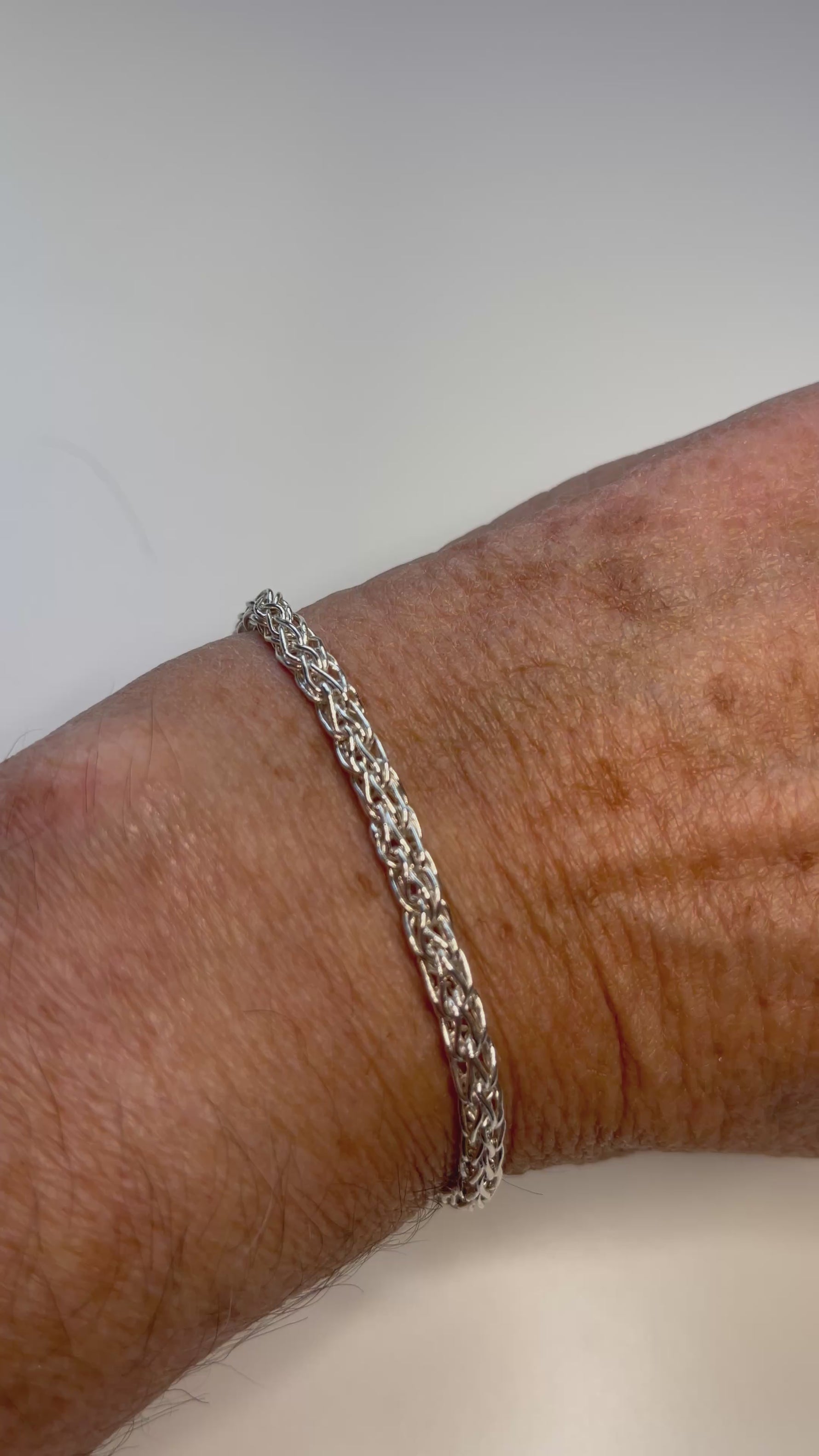 Carabella by Cheryl — video of model wearing the Gemma Fine Silver Bracelet, showcasing its handwoven silver texture and signature apple blossom clasp.
