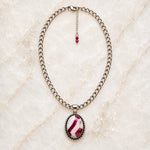 Sabine handcrafted tourmaline pendant necklace featuring a raspberry, blush and creamy-white gemstone on a polished silver-plated stainless steel chain, with a delicate three-tourmaline extender, displayed on white quartz.