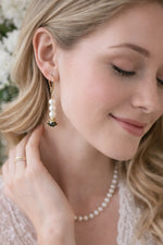 Serenity pearl drop earrings shown in profile with gentle movement and natural light