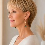 Side profile of an elegant woman wearing Tahitian South Sea black pearl drop earrings with crystal accents, highlighting the graceful length and movement of the design.